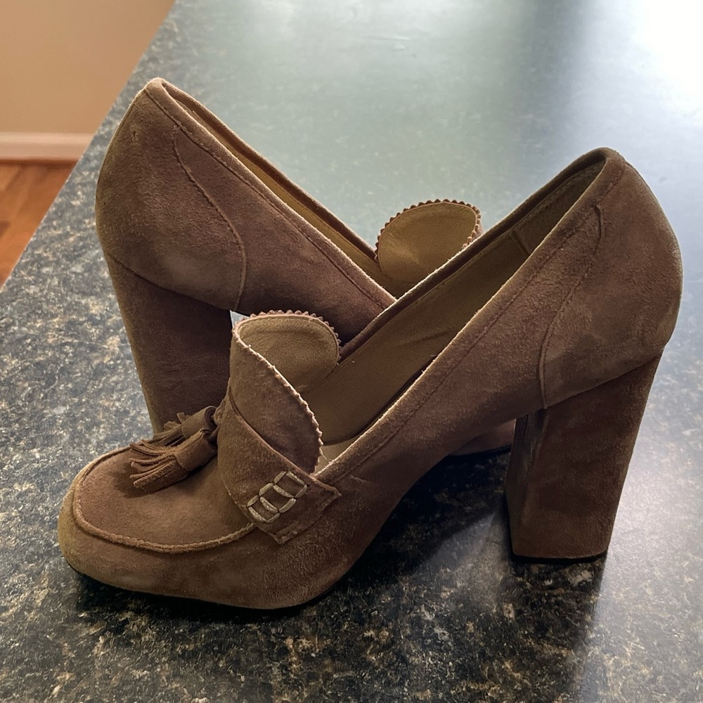High-heeled, tasseled suede loafers.